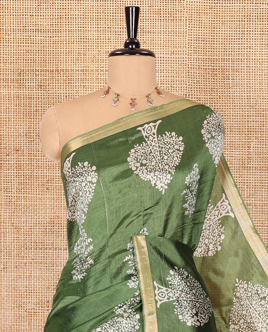Forest green tree motifs discharge printed banana pith saree, zari piping border, floral printed pallu, and a tree discharge printed blouse