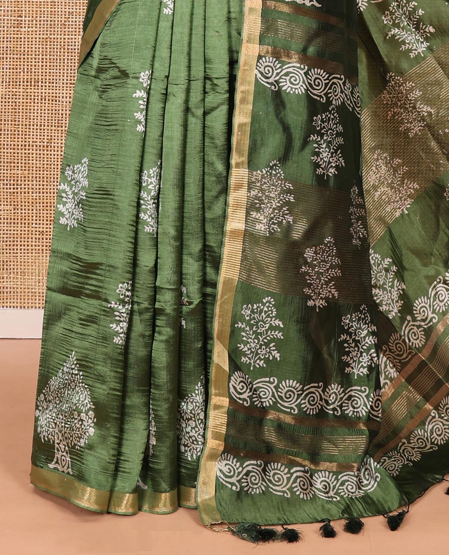Forest green tree motifs discharge printed banana pith saree, zari piping border, floral printed pallu, and a tree discharge printed blouse