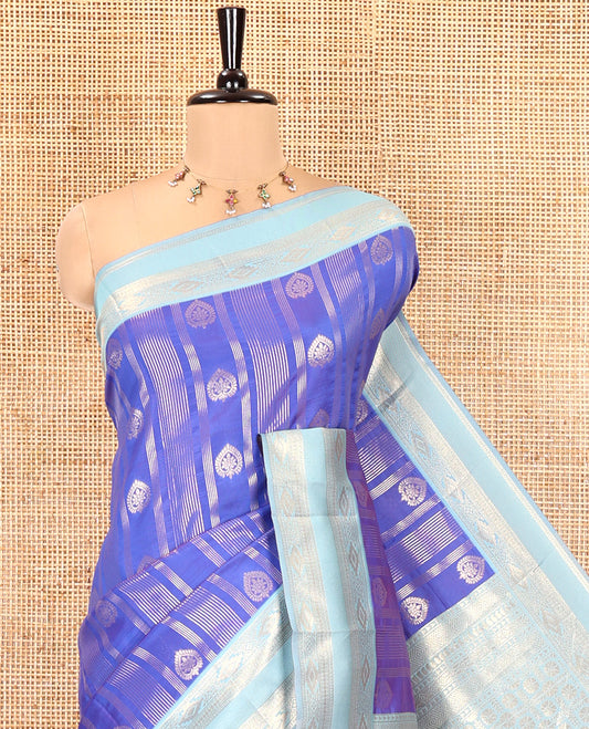 Royal Blue Litchi Saree, Detailed with Vaira Oosi Stripes and Zari Buttas on Its Body, Complemented by a Contrast Rettai Pettu Traditional Zari Design Border, an Intricately Designed Pallu, and Paired with a Contrast Blouse
