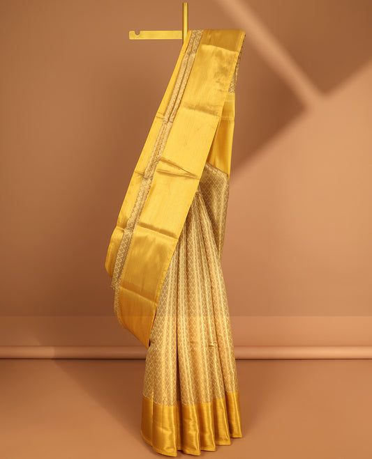 Light yellow leaf design semi tissue saree with contrast striped border & zari design pallu
