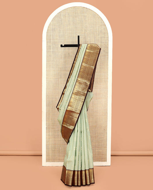 Green Vasundhara Lite Silk Mix Saree, Gracefully Detailed with Zari Butta Enclosed Checks on Its Body, Complemented by a Contrast Border of Rekku, Muthu, Banaras, Mayil, Rudraksham, and Kamalam Designs, Grand Jaal Pallu, and Paired with a Contrast Blouse