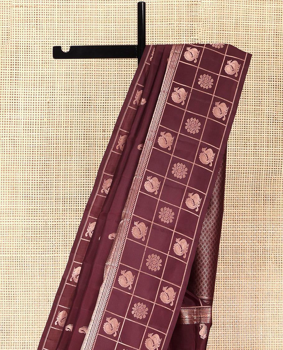 Brown Vasundhara Silk Saree, Artfully Detailed with Zari Buttas, Highlighted by a Zari Border of Rekku, Muthu, Jada Nagam, and Butta Enclosed Checks, Jaal Pallu, and a Matching Blouse
