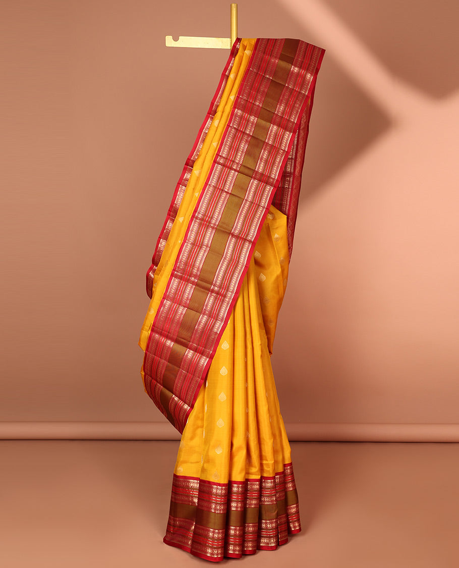 Yellow leaf buttas silk saree with contrast border of thilakam mokku, muthu, paun design & pallu of jaal design