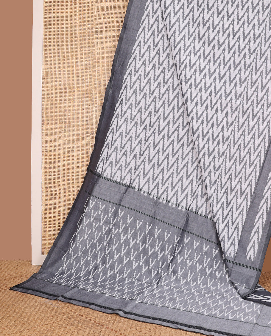 Cream chevron striped ikkat cotton saree, contrast plain grey border, and pallu of triangle buttas