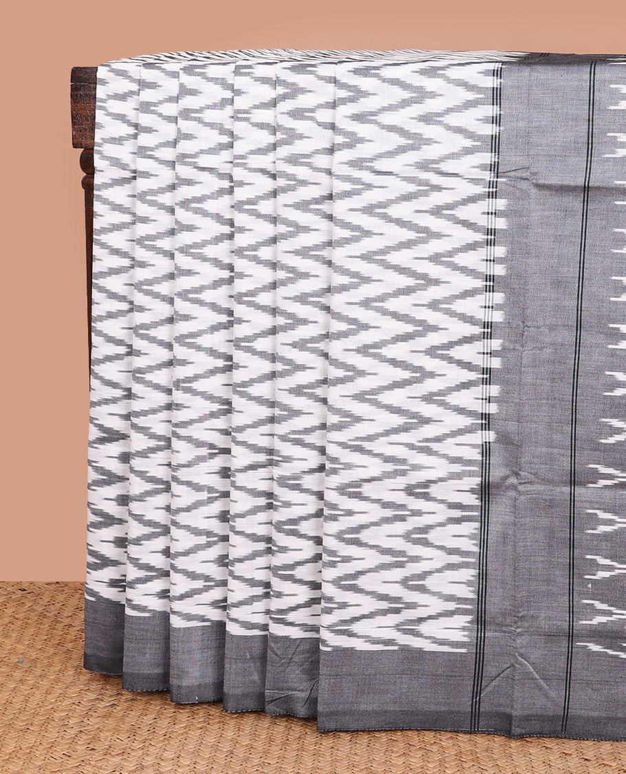 Cream chevron striped ikkat cotton saree, contrast plain grey border, and pallu of triangle buttas