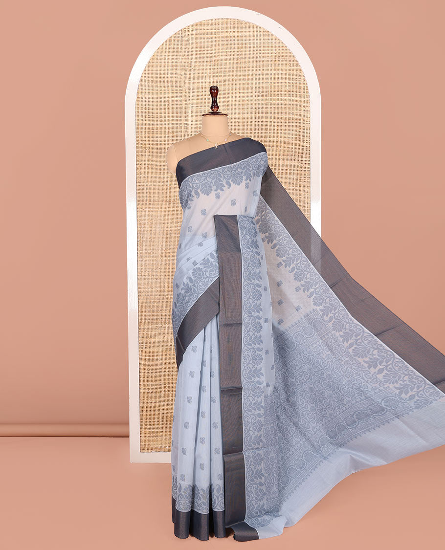Grey Semi-Silk Cotton Saree, Detailed with Buttas All Over Its Body, Complemented by a Contrast Border, Pallu Steeped with Floral Designs, and Paired with a Matching Blouse