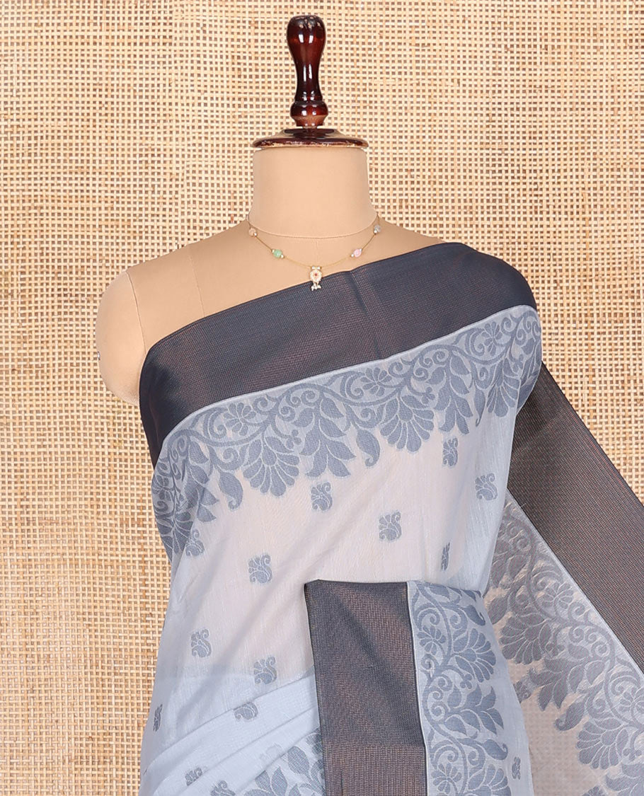 Grey Semi-Silk Cotton Saree, Detailed with Buttas All Over Its Body, Complemented by a Contrast Border, Pallu Steeped with Floral Designs, and Paired with a Matching Blouse