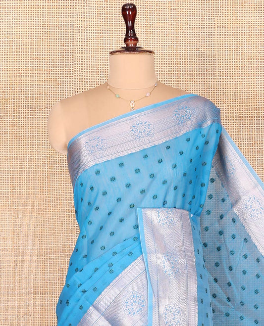 Blue Semi-Silk Cotton Saree, Sparsely Woven with Floral Buttas on Its Body, Highlighted by a Zari Traditional Border, Geometric Patterned Pallu, and Paired with a Matching Blouse