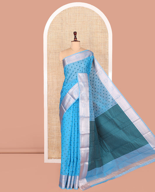 Blue Semi-Silk Cotton Saree, Sparsely Woven with Floral Buttas on Its Body, Highlighted by a Zari Traditional Border, Geometric Patterned Pallu, and Paired with a Matching Blouse