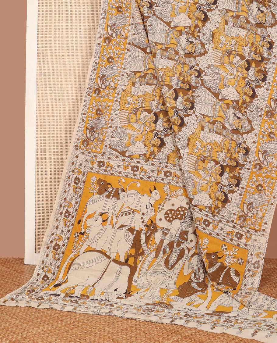 Yellow-mustrad human motifs machine-printed kalamkari cotton saree, peacock printed border & pallu of pichwai cow & Radha Krishna print