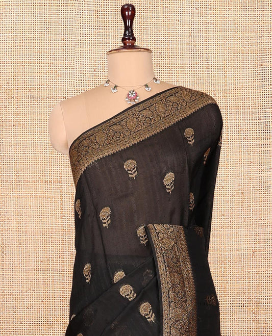 Black Matka Silk Saree, Mesmerized with Floral Buttas on Its Body, Highlighted by a Floral and Paisley Design Border, Pallu of Floral Designs, and Paired with a Matching Blouse