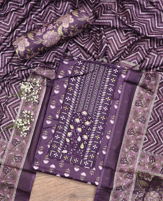 Purple Cotton Material Chudidar Set, Adorned with Floral Motifs Block Print, and Neck Embroidery on Its Cotton Top, a Floral Printed Bottom, and Paired with Chevron Printed Cotton Dupatta