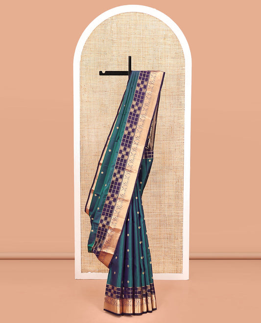 Blue Vasundhara Lite Silk Mix Saree, Ornamented With Zari Buttas All Over Its Body, Complemented by Contrast Border of Mayil-Chakram Enclosed Checks, Yaanai, and Arumbu Manga Designs, Grand Jaal Pallu and Paired with a Contrast Blouse