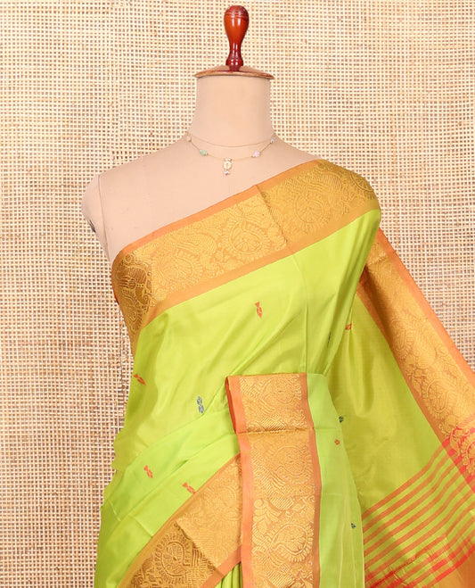 Green Banana Pith Saree Graced with Resham Buttas, Complemented by a Contrasting Border of Peacock Motifs, Pallu Steeped with Stripes and Resham Buttas, and Paired with a Contrast Blouse