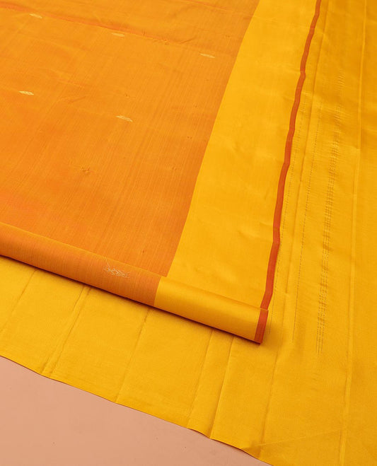 Orange Kanchipuram Silk Saree, Adorned with Zari Buttas All Over Its Body, Complemented by a Contrast Border of Leaf Designs, Pallu of Floral Designs, and Paired with a Contrast Blouse