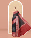 Black Dola Silk Saree, Detailed with Bandhani Dots on Its Body, Complemented by Contrast Border, Zari Striped  Pallu, and Paired with a Contrast Blouse