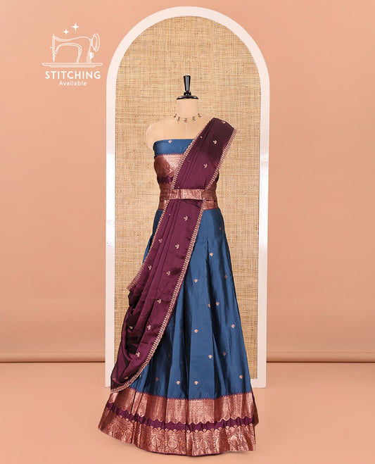 Blue-Purple Semi-Banarasi Half-Saree Enriched with Zari Buttas on Its Skirt, Complemented by a Contrast Traditional Zari Temple Rettai Pettu Border, Paired with a Matching Blouse, and a Satin Georgette Embroidered Scallop Dhavani