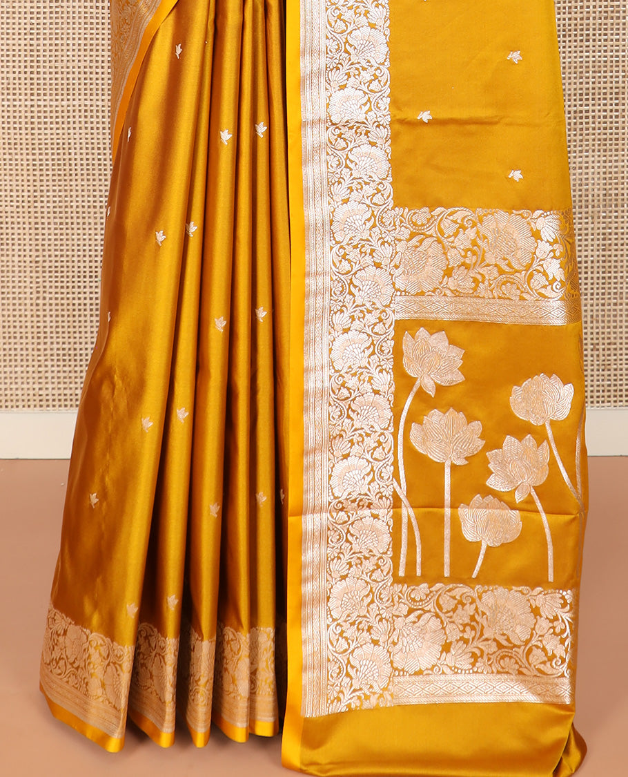 Yellow Semi-Banaras Satin Saree Subtly Sparkled with Zari Buttas, Self-Border Gleamed Up with Floral Creeper Designs, Pallu Creatively Woven of Lotus Motifs, and Paired with a Matching Blouse