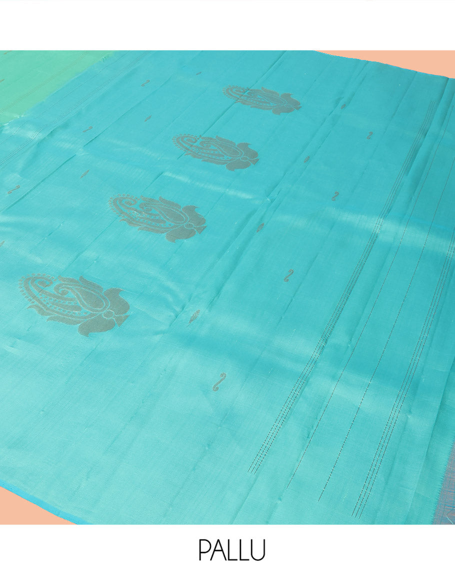 Turquoise Kanchipuram Silk Saree Woven with Zari Buttas, Subtly Sprakled Contrasting Border of Manga Designs, Zari Motifs Woven Pallu, and Paired with a Contrast Blouse