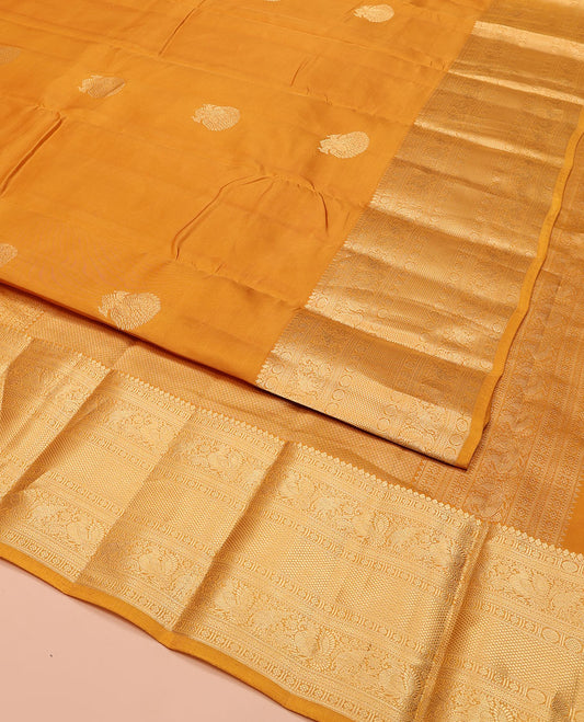 Yellow Vasundhara Lite Silk Mix Saree, Decorated with Zari Buttas, Highlighted by a Zari Border of Thilakam Mokku, Muthu, Kamalam, Mayil, Yaanai, Rettai Neli, and Mayil Kann Designs, Pallu of Mayil Kann Designs, and Paired with a Matching Blouse