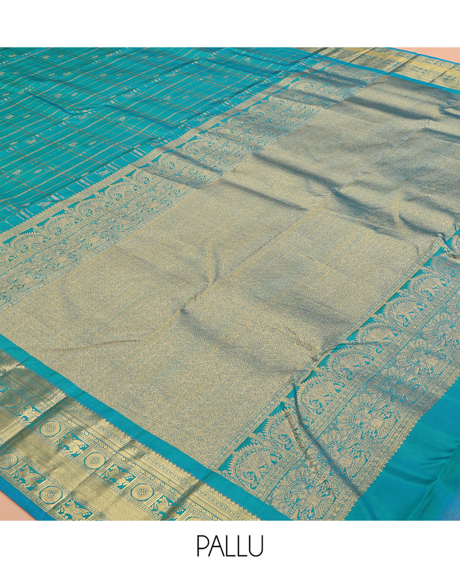 Neelambhari - Peacock Blue Vasundhara Silk Saree Gleamed Up with Zari Buttas Enclosed in Zari Checks, Featuring a Zari Border of Kuthirai and Chakra Designs, Rich Zari Pallu, with a Matching Blouse
