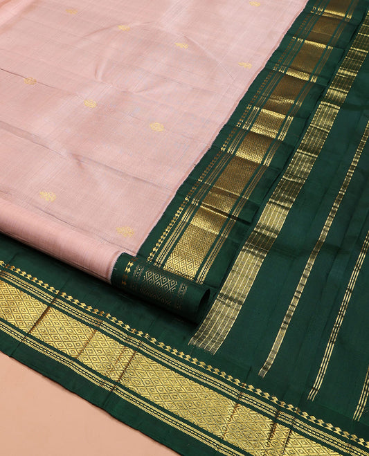 Peach Kanchipuram Silk Saree, Subtly Sparkled with Zari Buttas on Its Body, Complemented by a Contrast One-Sided Korvai Border of Panner Sombu, Banaras, Muthu, and Mayil Kann Designs, Pallu Steeped with Zari Designs, and Comes Without a Blouse