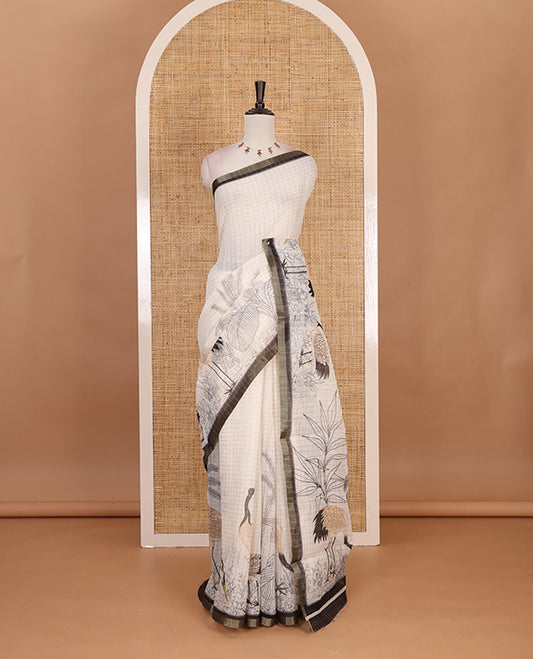 White with green zari checks linen saree with contrast border and unique designs of pallu along with contrast plain blouse