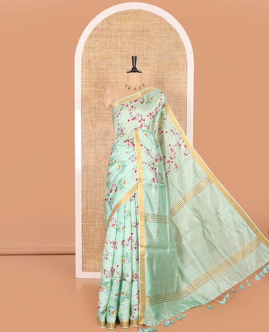 Mint Green Banana Pith Saree Prettified with Multi-Color Floral Vine Print, Subtle Small Bavanji Border, Gleaming Zari Striped Pallu, and Complemented with a Contrast Floral-Printed Blouse