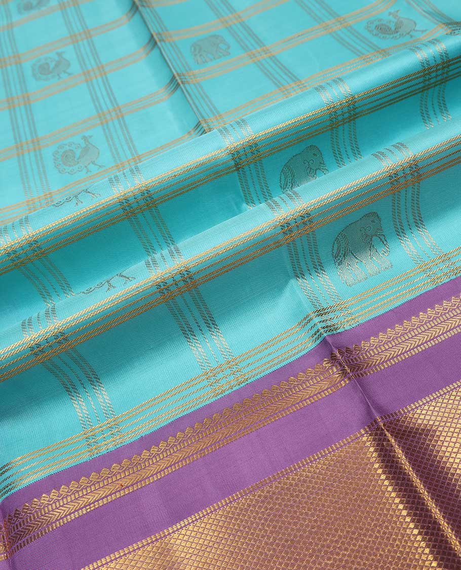 Blue puresilk halfsaree, yaanai and mayil butta enclosed checked skirt, contrast blouse and border of traditional designs in zari, and zari design dhavani