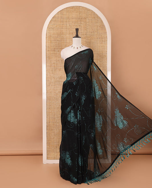 Borderless black 60 gm georgette saree features floral vine designs blue glitter embroidery work, contrast plain blouse