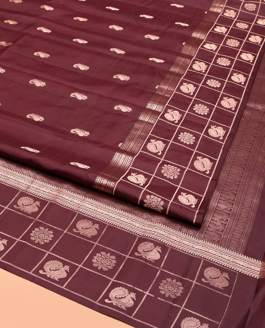 Brown Vasundhara Silk Saree, Artfully Detailed with Zari Buttas, Highlighted by a Zari Border of Rekku, Muthu, Jada Nagam, and Butta Enclosed Checks, Jaal Pallu, and a Matching Blouse