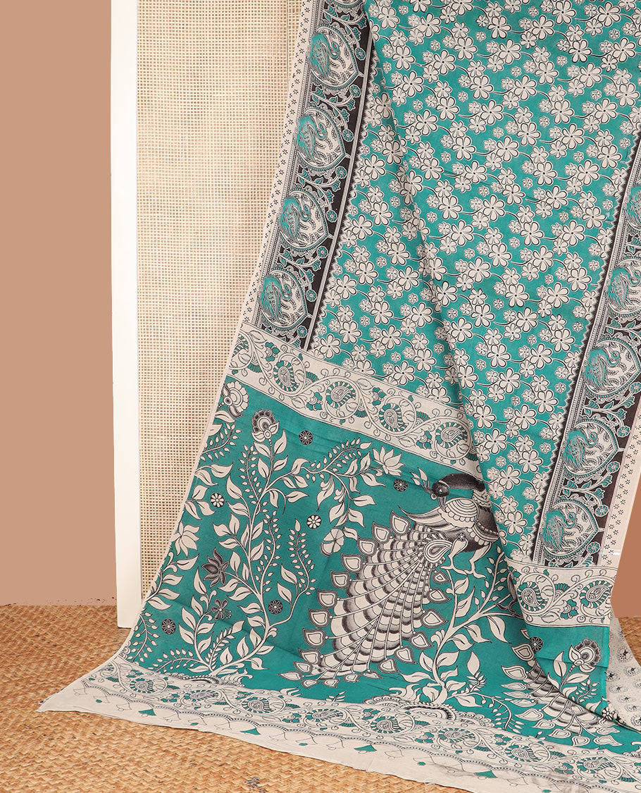 Green floral machine-printed cotton saree, contrast printed border, and pallu of Kalamkari floral and peacocks