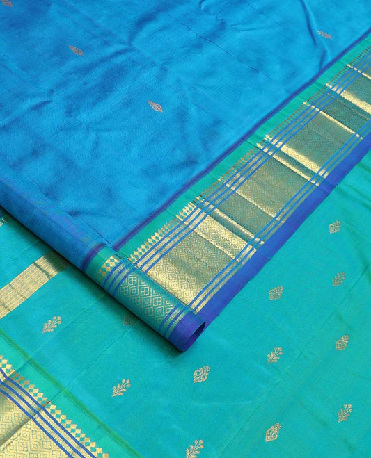 Blue zari buttas Kanchipuram silk saree, contrast one-sided border of paneer sombu, banaras, and jaal designs, and zari design pallu