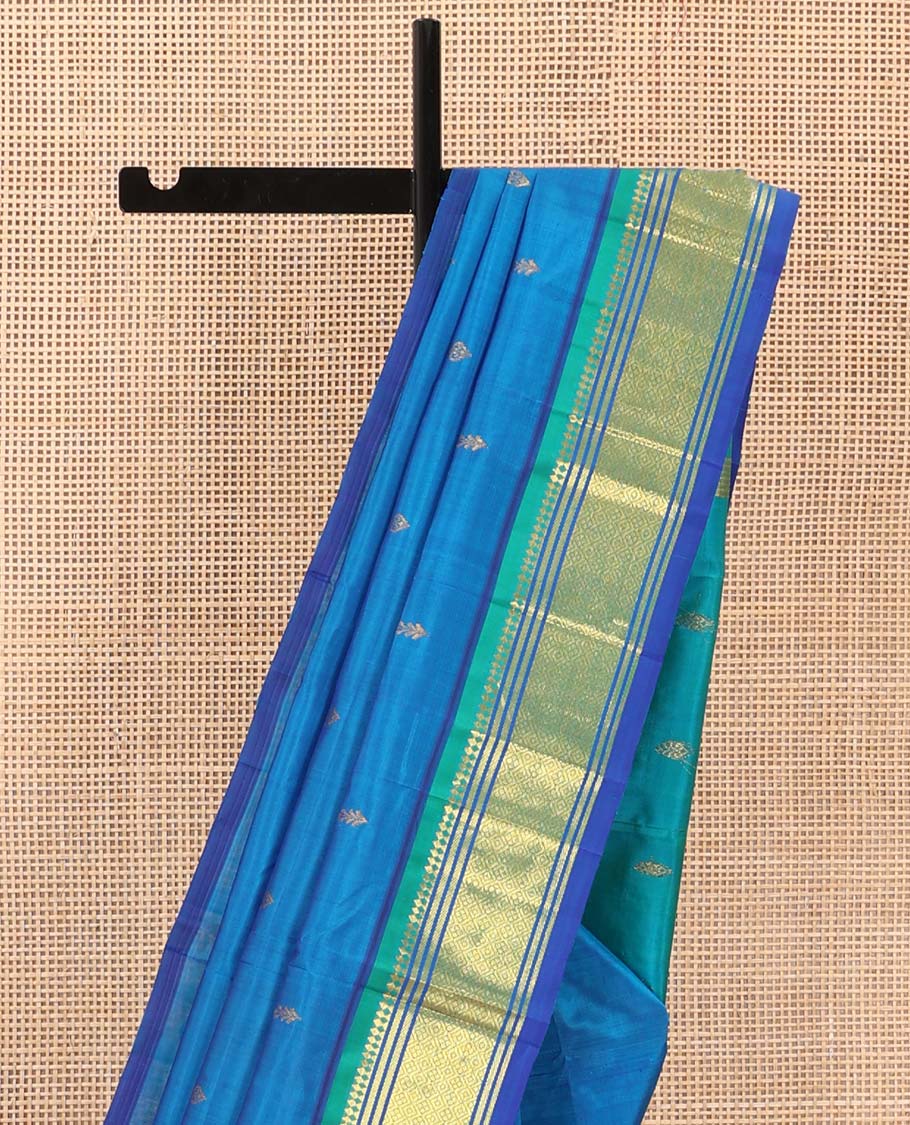 Blue zari buttas Kanchipuram silk saree, contrast one-sided border of paneer sombu, banaras, and jaal designs, and zari design pallu