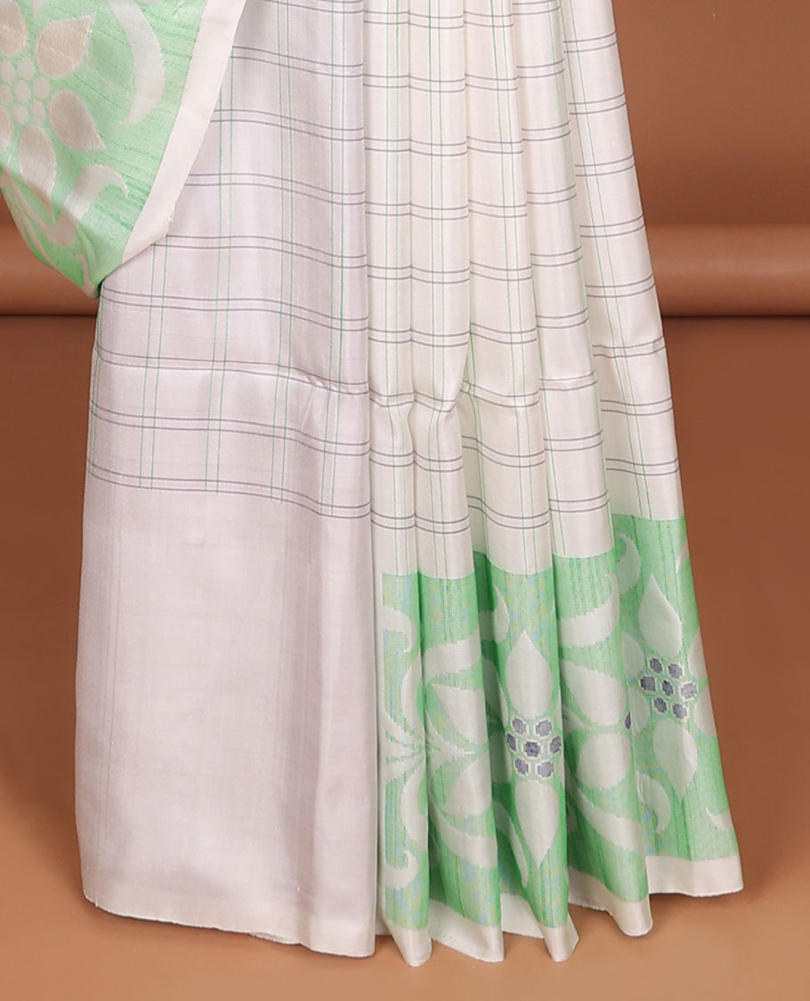 Cream-checked soft silk saree, floral ikkat design border & contrast floral design pallu