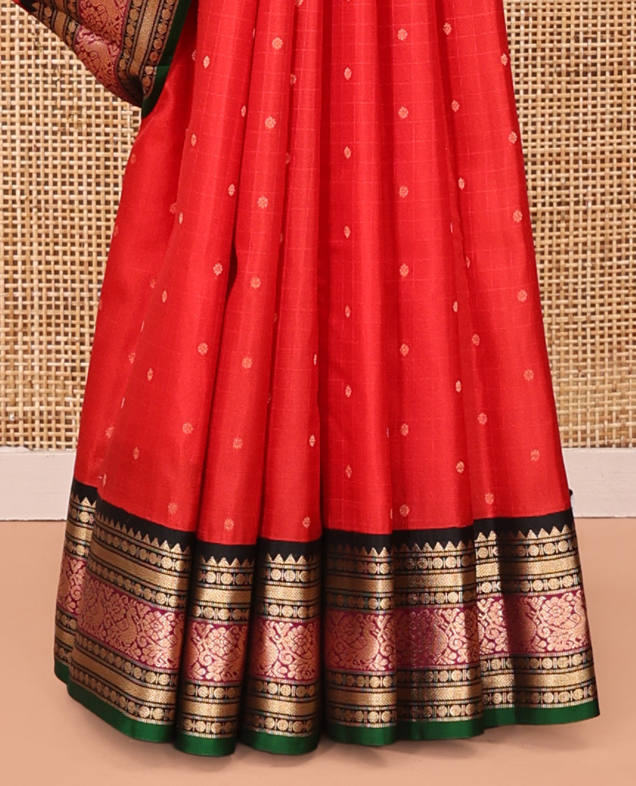 Red Vasundhara Silk Saree, Sparsely Woven with Zari Buttas All Over Its Body, Complemented by a Contrast Border of Rekku, Muthu, Poun, Kathir, and Mayil Designs, Beautifully Bedecked Pallu, and Paired with a Contrast Blouse