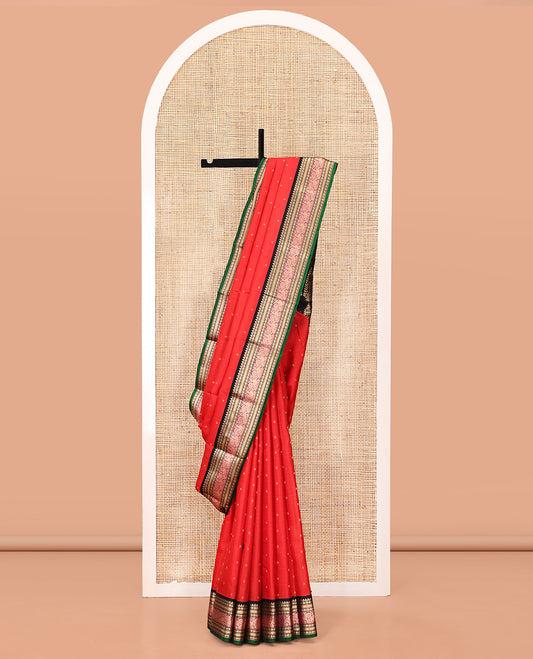 Red Vasundhara Silk Saree, Sparsely Woven with Zari Buttas All Over Its Body, Complemented by a Contrast Border of Rekku, Muthu, Poun, Kathir, and Mayil Designs, Beautifully Bedecked Pallu, and Paired with a Contrast Blouse