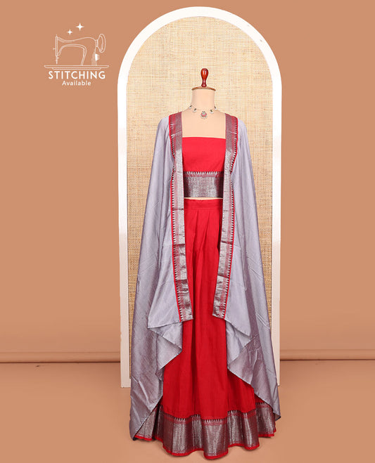 Red plain cotton half-saree with traditional bordered skirt, matching blouse, and a contrast traditional bordered dhavani