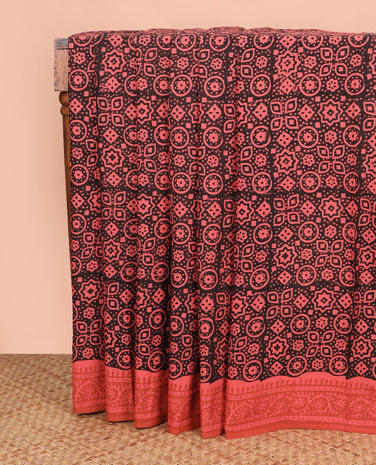 Black Ajrakh printed mixed cotton saree, contrast traditional floral creeper border, and geometric printed blouse