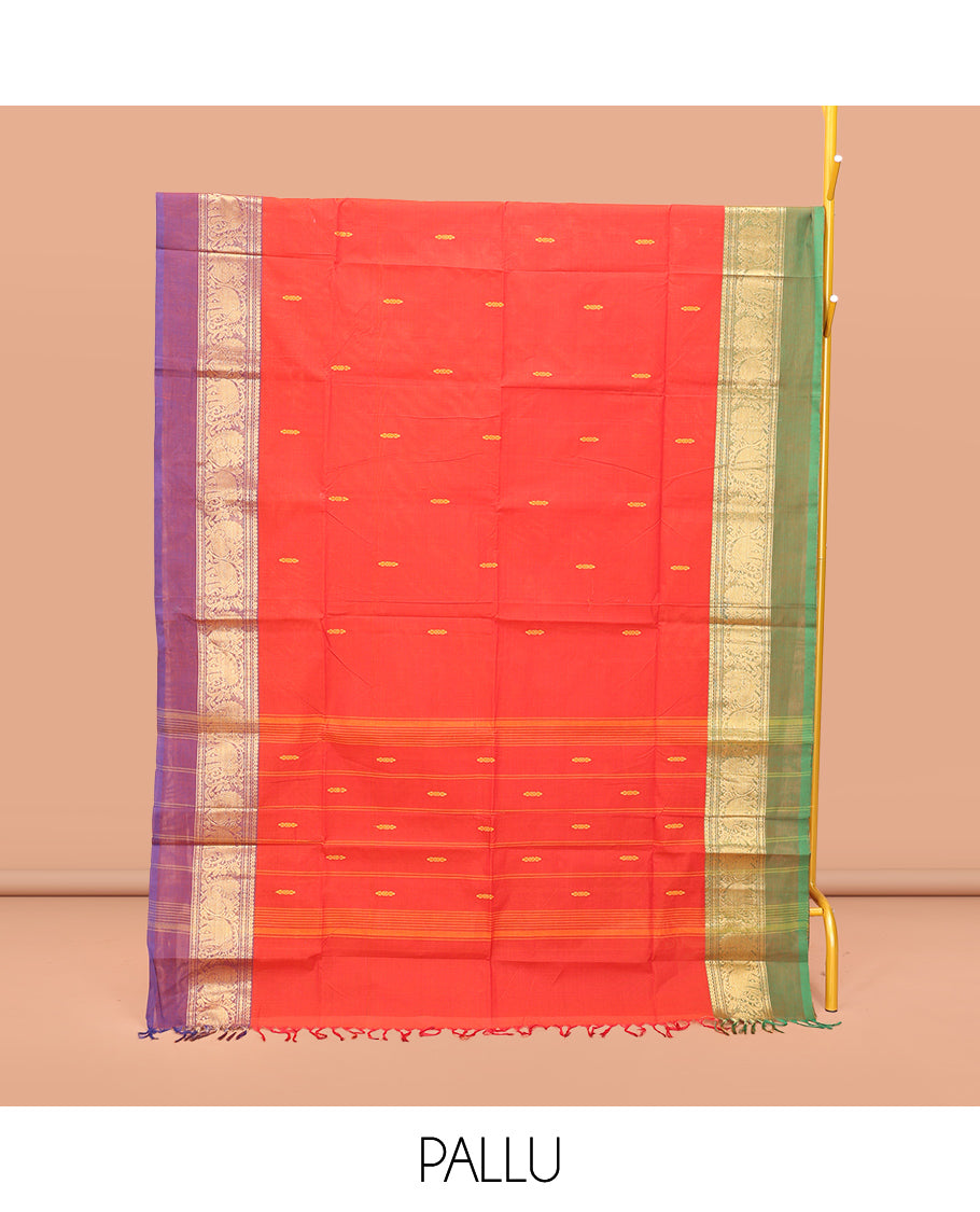 Red Chettinad Cotton Saree, Delicately Woven with Thread Buttas All Over Its Body, Complemented by a Contrast Ganga-Jamuna Kal Eragina Border of Kodi Peacock and Elephant Designs, Pallu of Buttas and Stripes, and Paired with a Matching Blouse