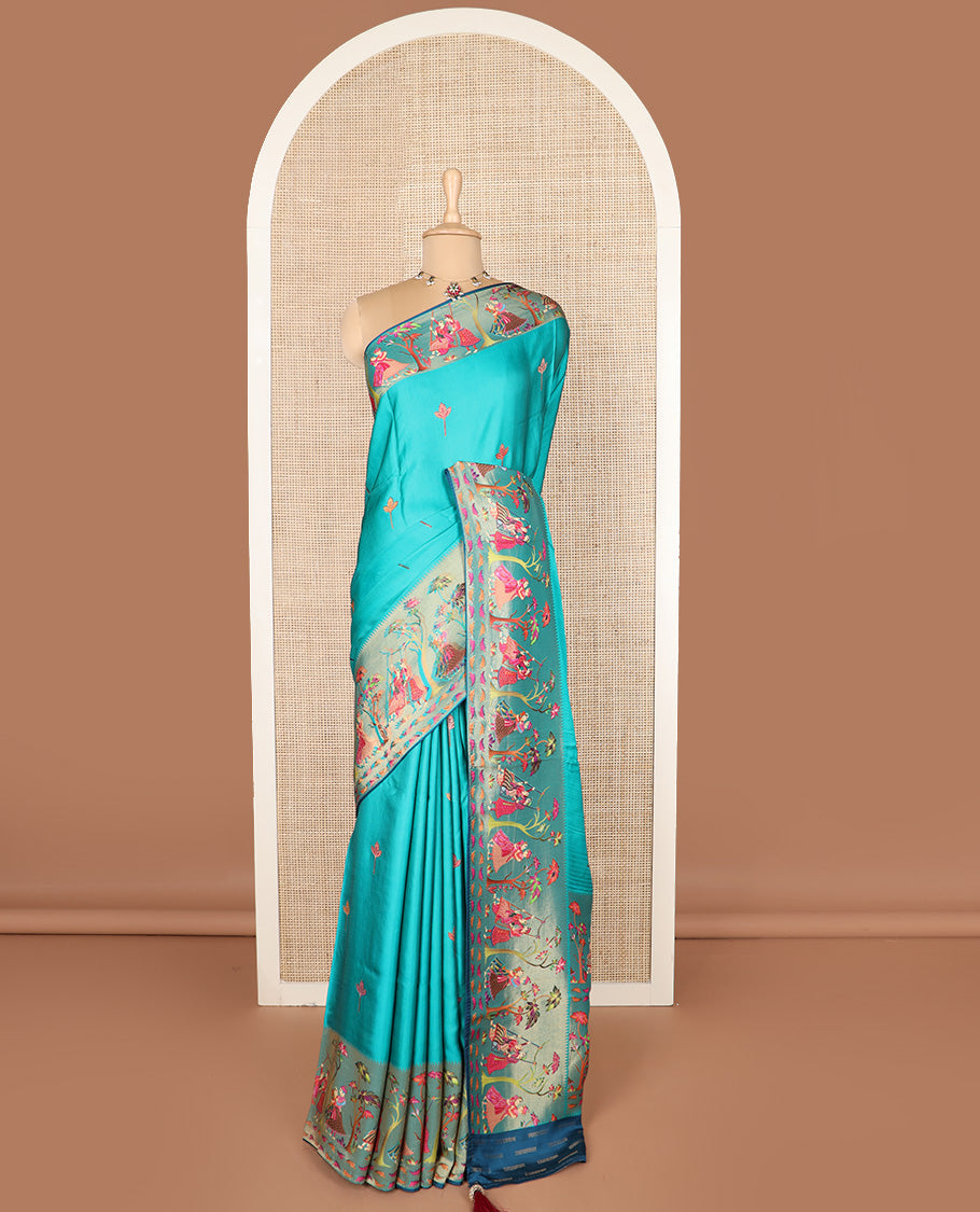 Blue unique motifs printed dola silk saree, gleaming zari border, and pallu of Mughal-style man and women motifs