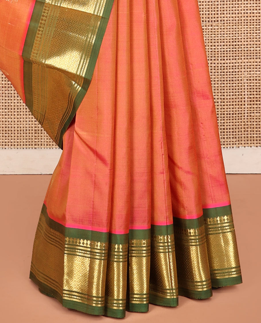 Orange Kanchipuram Silk Saree, Embellished with Zari Buttas, a Contrast One-Sided Border of Panner Sombu, Muthu, Bananras, and Mayil Kann, Zari Design Pallu, and No Blouse