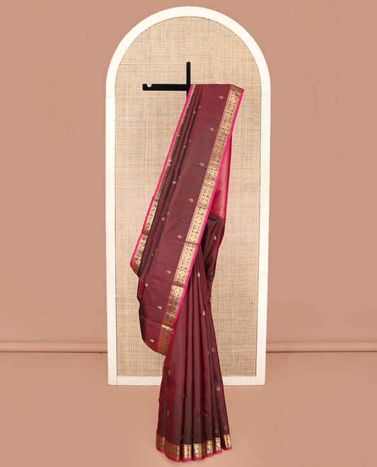 Red Wine Kanchipuram Silk Saree, Adorned with Thilakam Buttas All Over Its Body, Complemented by a Contrast Border of Rekku, Muthu, Banaras, Mayil, and Chakram Designs, Grand Jaal Pallu, and Paired with a Contrast Blouse