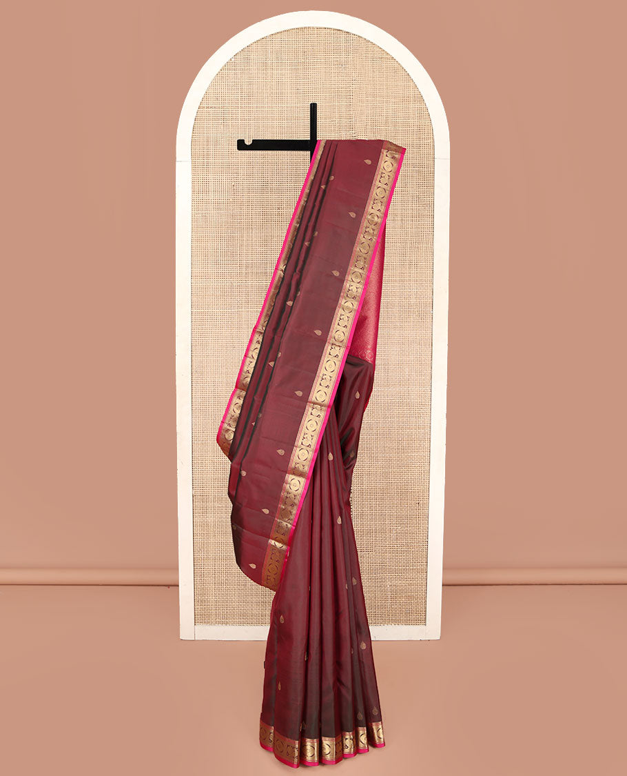 Red Wine Kanchipuram Silk Saree, Adorned with Thilakam Buttas All Over Its Body, Complemented by a Contrast Border of Rekku, Muthu, Banaras, Mayil, and Chakram Designs, Grand Jaal Pallu, and Paired with a Contrast Blouse