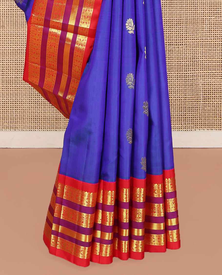 Blue Kanchipuram Silk Saree, Meticulously Crafted with Zari Buttas on Its Body, Complemented by Contrast One-Sided Border of Thilakam Mokku, Neli, Rudraksham, and Mayil Designs, Grandly Woven Pallu of Floral Designs, and Comes Without a Blouse