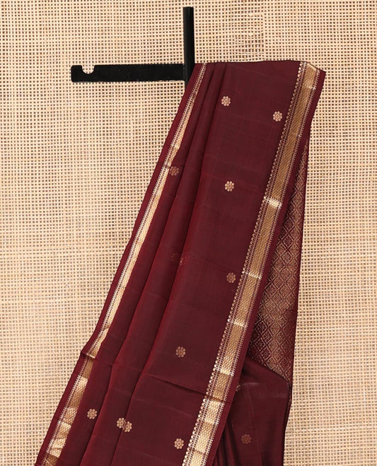 Maroon Mayuri Soft Silk Saree, Enthralled with Floral Buttas All Over Its Body, Subtly Woven Border of Salngai, Muthu, Banaras, and Kuyil Kann Designs, Sparsely Woven Jaal Pallu, and Paired with a Matching Blouse