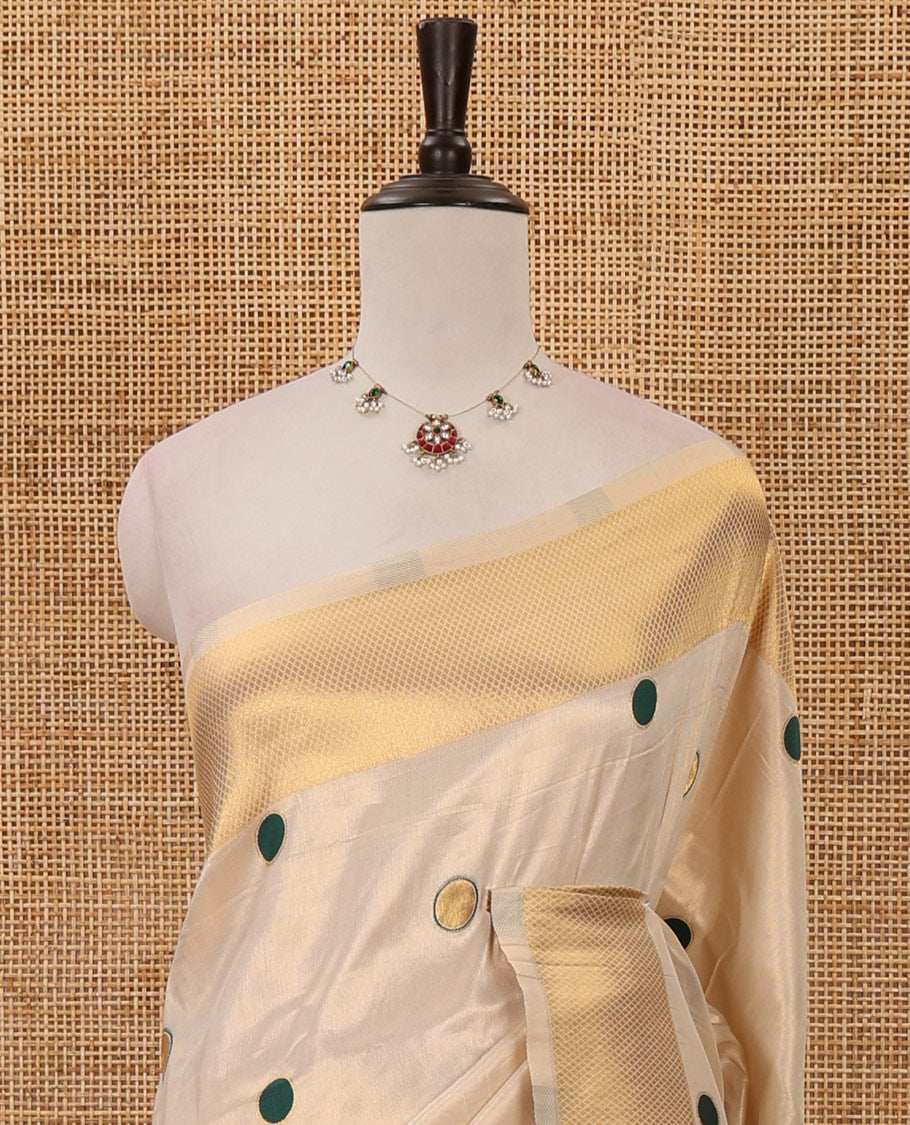 Cream small green polka dots banarasi tissue saree, zari border, pallu of green polka dots & running plain blouse