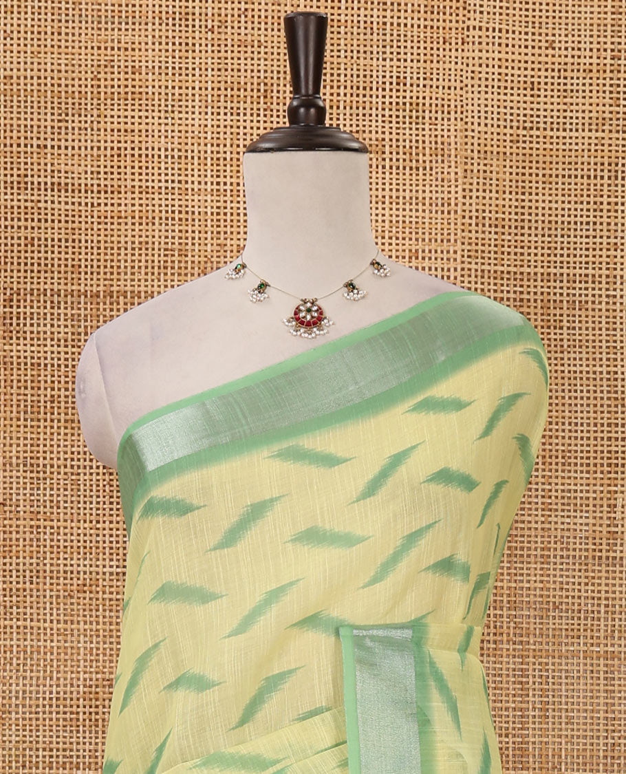 Lemon yellow ikkat digitally printed linen saree, contrast zari bavanji border,chevron ikkat printed pallu & ikkat jaal printed contrast blouse