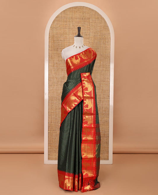 Bottle green checked semi-tafeta saree, contrast temple zari elephant motifs border, striped pallu & matching checked zari border blouse