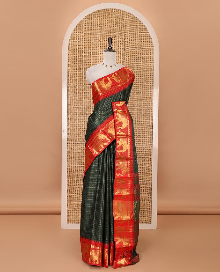 Bottle green checked semi-tafeta saree, contrast temple zari elephant motifs border, striped pallu & matching checked zari border blouse